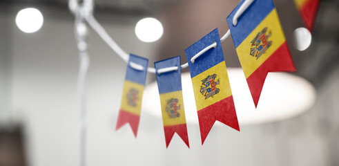 A garland of Moldavia national flags on an abstract blurred background