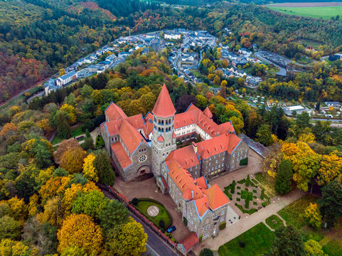 Aerial drone Shot of Abbey in Clervaux, Luxembourg in mystery evening twilight 