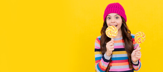 happy kid girl hold lollipop sweet, carefree. Teenager child with sweets, poster banner header, copy space.