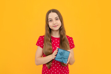 Portrait of teenager child girl 12, 13, 14, years old holding Christmas gift box. Teen giving birthday gift.