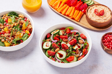 Vegan or veganuary feast with various salads ad healthy plates on light gray table