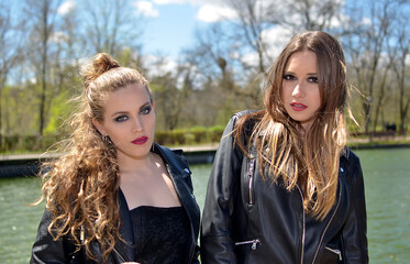 Portrait of a couple woman outdoors with leather jacket