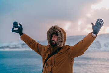 A photographer in the cold Skavdinava regions tries to take a photo for journalism in a strong...