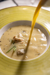 Pouring soup into plate