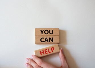 You can help symbol. Wooden blocks with words You can help. Beautiful white background. Businessman hand. Business and You can help concept. Copy space.