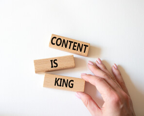 Content is king symbol. Concept words Content is king on wooden blocks. Businessman hand. Beautiful white background. Business and Content is king concept. Copy space.