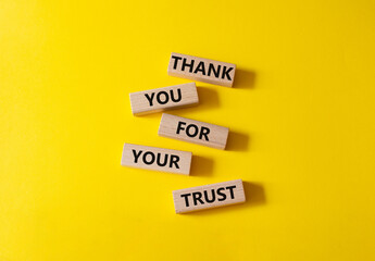 Thank you for your trust symbol. Wooden blocks with words Thank you for your trust. Beautiful yellow background. Business and Thank you for your trust concept. Copy space