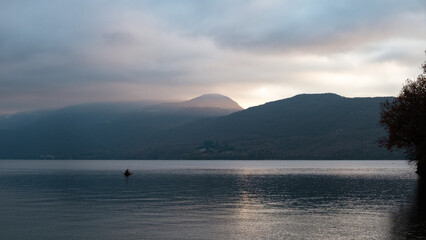 Fototapeta na wymiar zen sunset over the lake surrounded by mountains, 