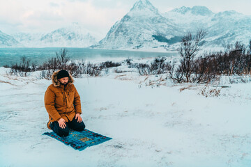 Fototapeta na wymiar A Muslim traveling through arctic cold regions while performing the Muslim prayer namaz during breaks