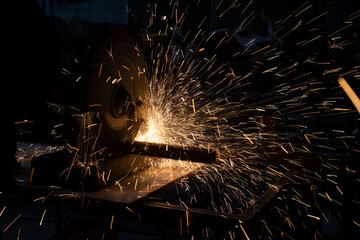 Saw cuts metal. Sparks from friction. Lot of sparks from sawing steel.