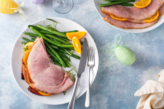 Easter ham served on a plate with green beans