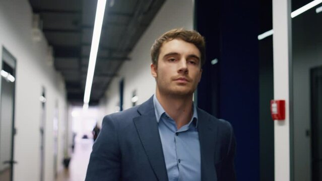 Pensive employee walking office hallway closeup. Tired man executive leaving