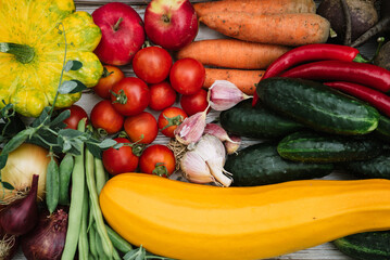 wooden white tray with fresh farm raw vegetables, tomatoes, cucumbers, carrots, peas, zucchini, beets, onions, garlic, apples, chili peppers, green beans 1