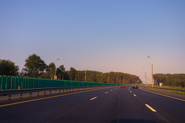 Evening view at sunset. Highway road in the countryside, roadside and asphalt