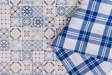 blue patterned tile with blue and white checkered cloth