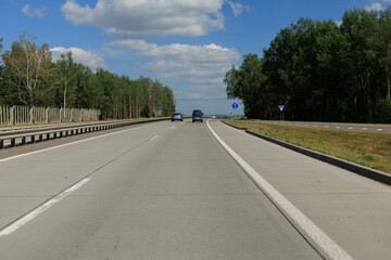 Highway wide road, transport and blue sky with clouds on a summer day