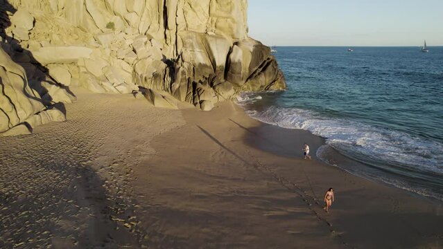 Aerial view of a person walking on the beach at Playa del Divorcio, Cabo San Lucas, Baja California, Mexico.