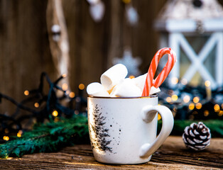 hot Christmas drink with marshmallow on wooden table