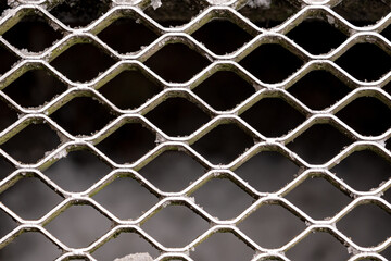 Fototapeta premium metal grid background, checkered metal texture background in winter with little frost