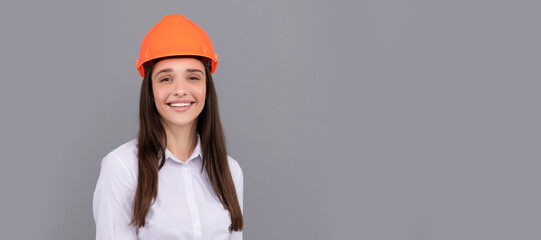 cheerful woman in safety hardhat and white shirt, businesswoman. Woman isolated face portrait, banner with mock up copy space.