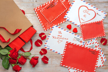 Red roses in bouquets. Letters, mail, craft shopping bag, greetings, valentines, stamps, stars,...