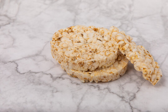 Rice cakes on a white marble background. Close-up. Healthy food. Diet food.