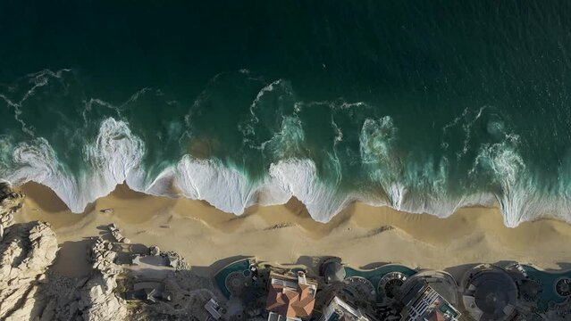 Aerial view of waves breaking on the shoreline at Playa del Divorcio, Cabo San Lucas, Baja California, Mexico.