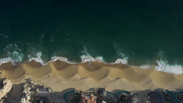Aerial view of waves breaking on the shoreline at Playa del Divorcio, Cabo San Lucas, Baja California, Mexico.