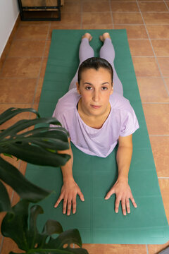 yoga. Girl doing yoga exercises at home. Sphinx position	