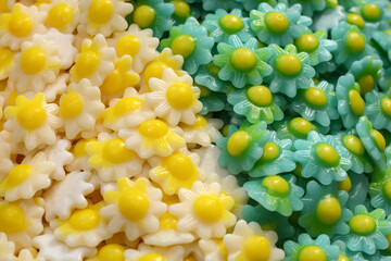 Lots of small green and yellow marmalade candies. Texture of jelly candies