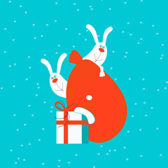 Two cute happy smiling white bunnies or hares peeking out from behind Santa claus red bag with christmas gifts.