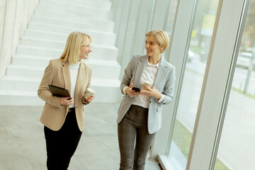 Business women walking in the office corridor