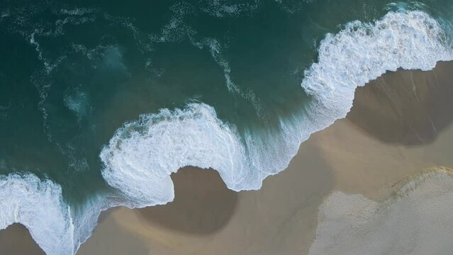 Aerial view of waves breaking on the shoreline at Playa del Divorcio, Cabo San Lucas, Baja California, Mexico.