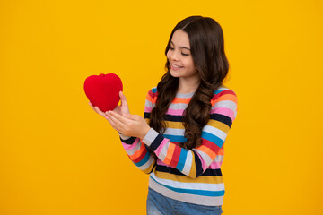 Lovely child teen girl with shape heart love holiday and valentine symbol. Valentine or birthday day. Gift heart present. Happy teenager, positive and smiling emotions of teen girl.