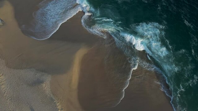 Aerial view of waves breaking on the shoreline at Playa del Divorcio, Cabo San Lucas, Baja California, Mexico.