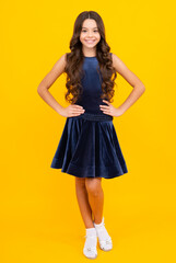 Full length of teenager child girl wearing ball dress on yellow isolated background. Happy girl face, positive and smiling emotions.