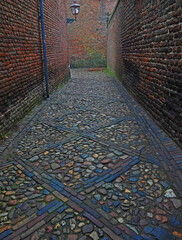 Decoratively laid paving stones in a medieval alley. Location: Zutphen, Netherlands