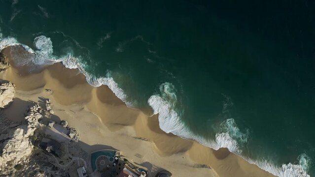 Aerial view of waves breaking on the shoreline at Playa del Divorcio, Cabo San Lucas, Baja California, Mexico.