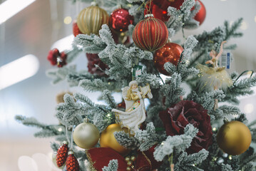 Fototapeta na wymiar Decorated Christmas tree on blurred background, Christmas background - baubles and branch of spruce tree