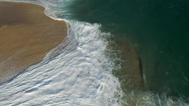 Aerial view of waves breaking on the shoreline at Playa del Divorcio, Cabo San Lucas, Baja California, Mexico.