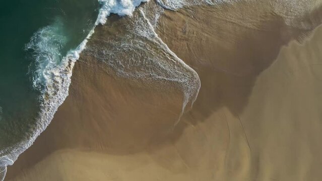 Aerial view of waves breaking on the shoreline at Playa del Divorcio, Cabo San Lucas, Baja California, Mexico.