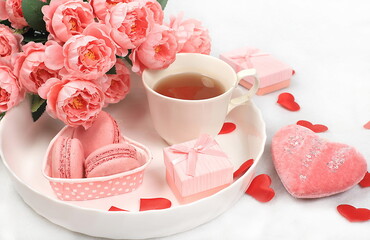 Concept for Valentine's Day or Women's Day, Mother's Day, banner. Greeting card, pink roses, tea and hearts, marshmallows on a light background, congratulations on the holiday, birthday, 