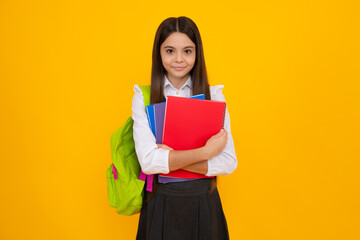 Fototapeta School teenager child girl 12, 13, 14 years old with school bag book and copybook. Teenager schoolgirl student, isolated background. Learning and knowledge. obraz