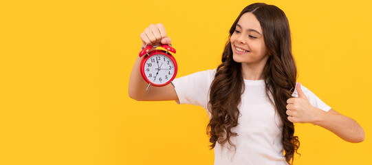 happy child hold retro alarm clock showing time, thumb up. Teenager child with clock alarm, horizontal poster. Banner header, copy space.