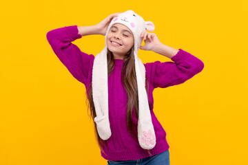 Obraz na płótnie Canvas teen girl in knitwear. express positive emotion. happy funny child in earflap hat.