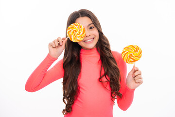 Funny child with lollipop over white isolated background. Sweet childhood life. Teen girl with...