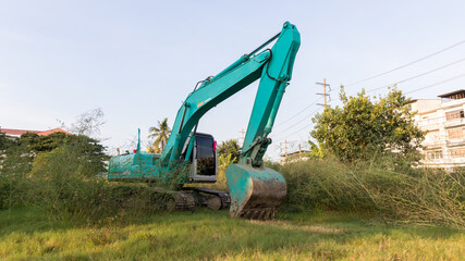 The excavator digs a soil. Digger loading trucks with soil. Excavator working on earthmoving at open pit mining. Excavator working on earthmoving at construction site.