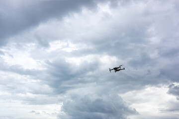 Drone copter flying with digital camera. Drone with high resolution digital camera. Flying camera take a photo and video. The drone with professional camera takes pictures of the misty mountains.