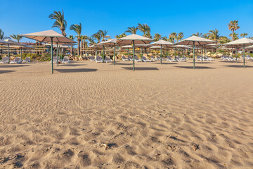 Empty sandy beach in sunny weather under blue sky in not season time