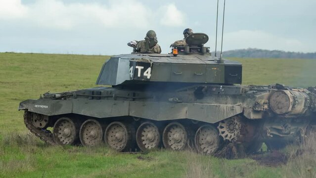close up of British army Challenger 2 ii FV4034 main battle tank on a military combat exercise, gunner seeking target with the gun turret in rapid motion, Wiltshire UK